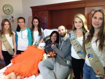Girl scouts visiting a patient