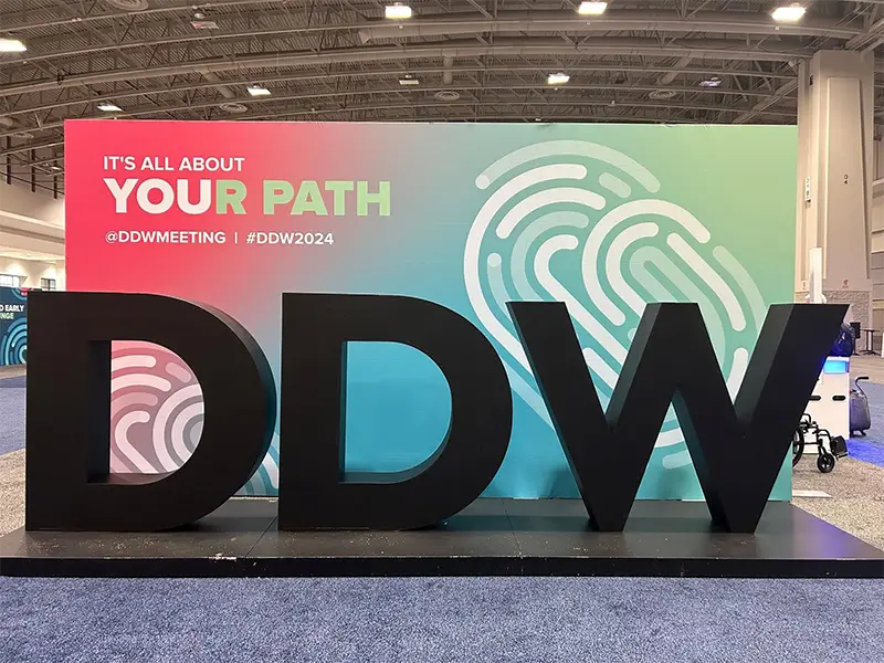 Image of black DDW letters in front of bright background