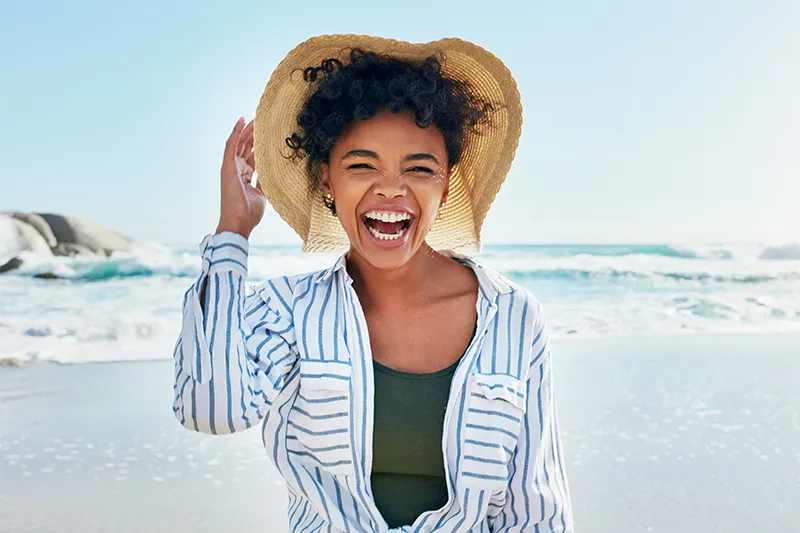 image of girl smiling on the beach