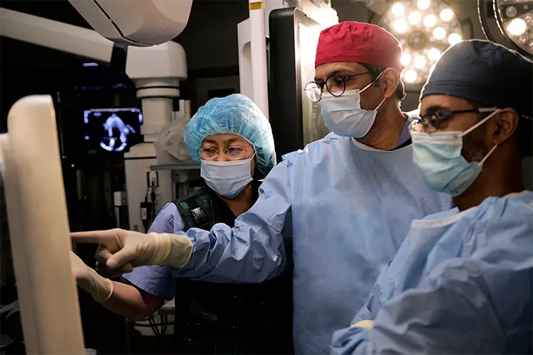 image of Dr. Kodali, Dr. Hahn, and Dr. George in the operating room