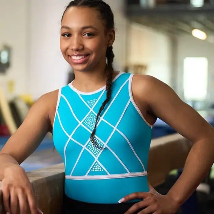 Olivia Kelly posing by balance beam