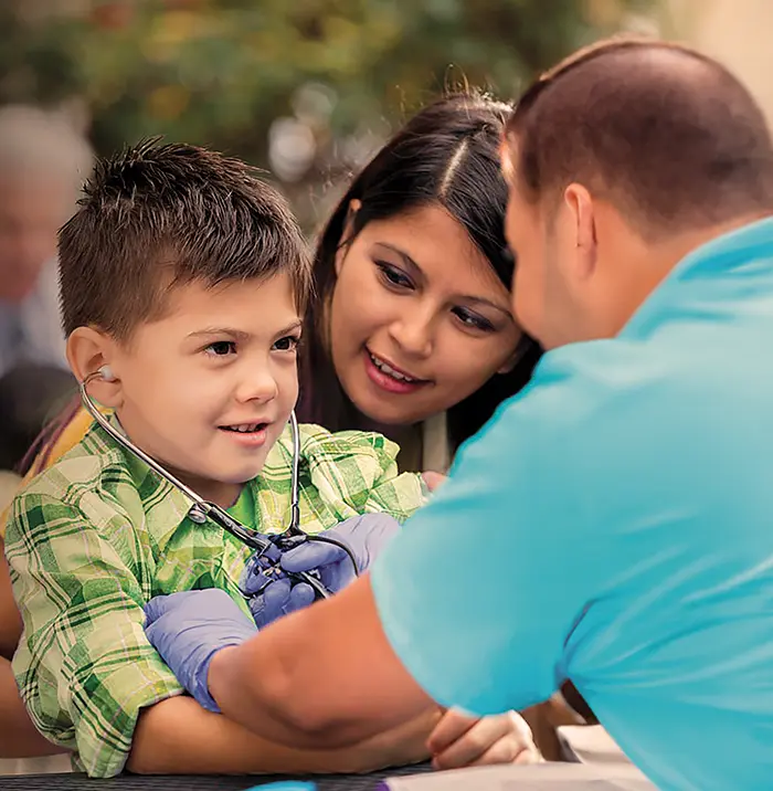 doctor checking a kids heart through stethoscope 