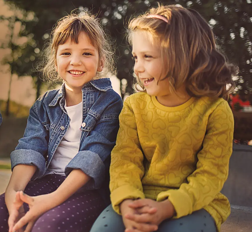 two kids sitting outdoors