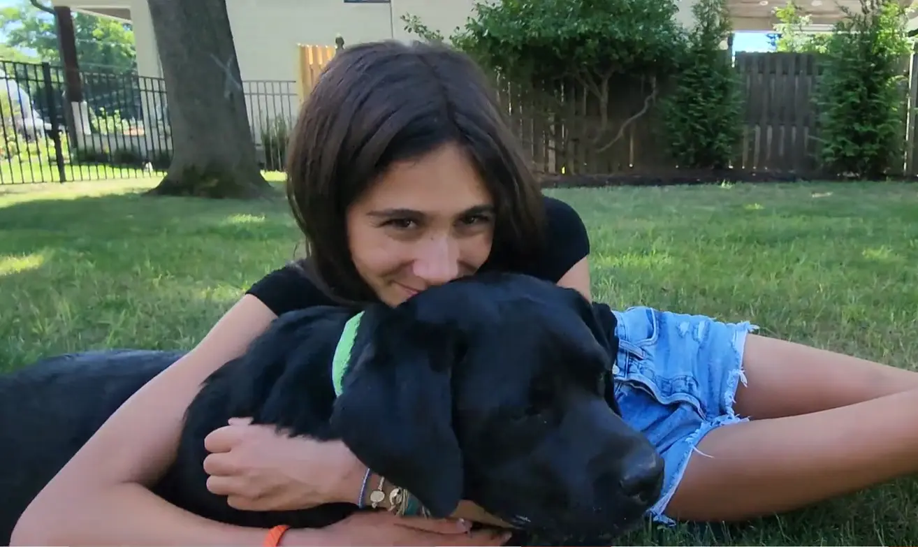 Saige Levitt playing with her Dog