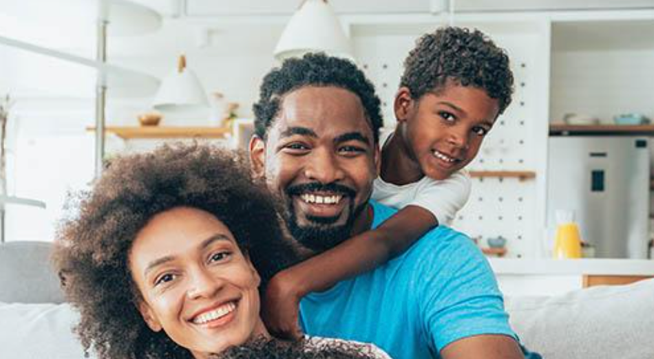 an African American family, smiling at camera