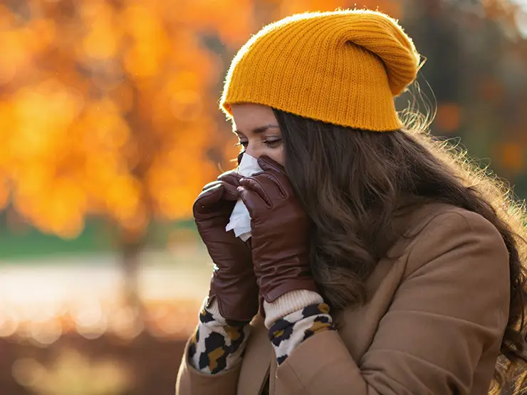 image of person blowing nose in tissue