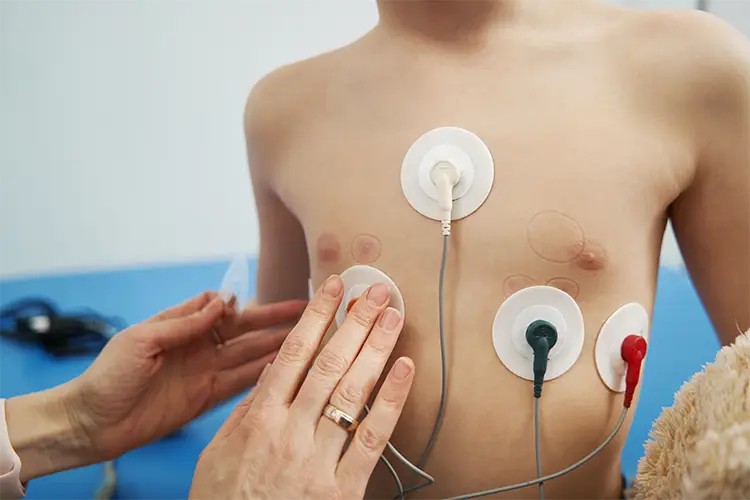 Child receiving ECG monitoring to check heart health