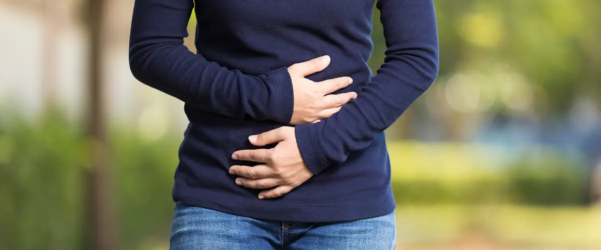 A woman feeling pain in her stomach area